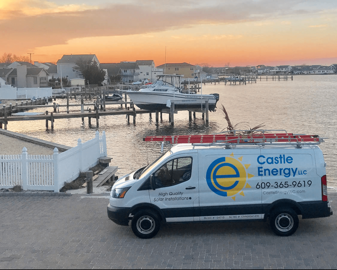 Castle Energy truck van parked in front of a bay during a sunset