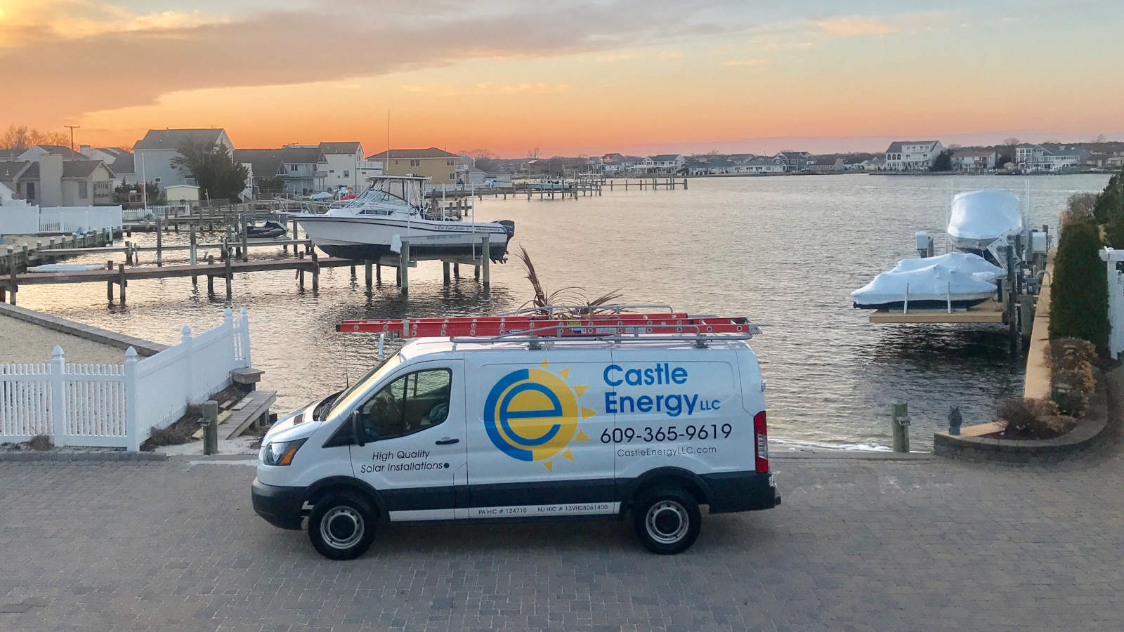 Castle Energy van parked in front of a bay during the sunset